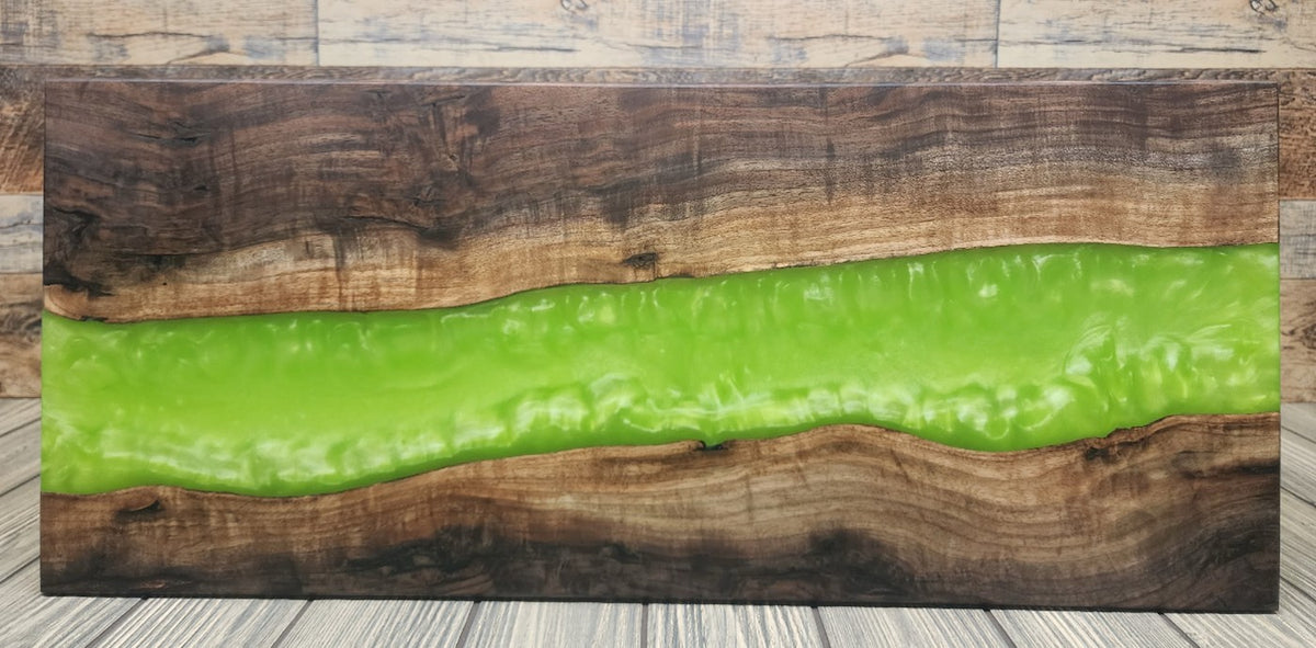 Live-edge walnut charcuterie board with a green resin river.