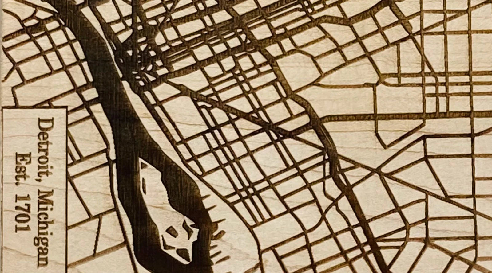 A street map of Detroit laser-engraved into pale maple, labelled Detroit, Michigan, Est. 1701.