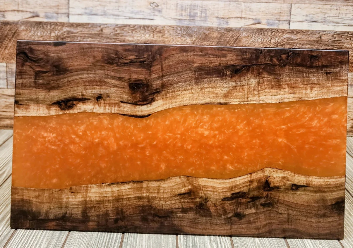Board with an orange resin river engraved for a private client