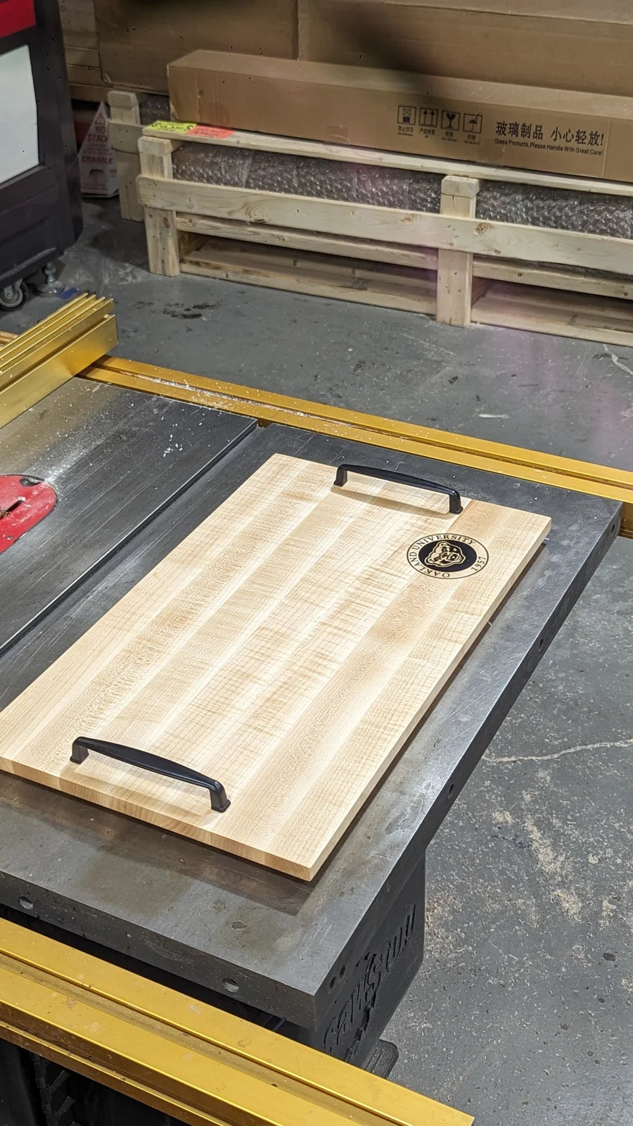 An Oakland University tray on the table saw during cutting.
