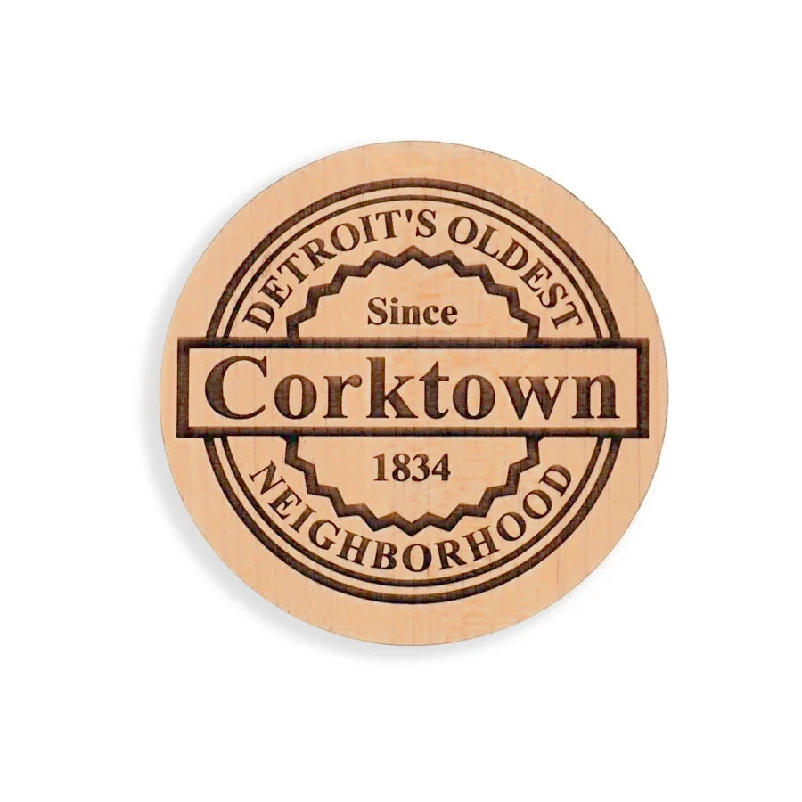 A coaster engraved with a Corktown design.