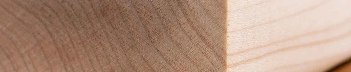 Close grain of a planed maple blank, pale cream with fine even grain.