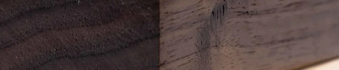 Close grain of a planed walnut blank, dark chocolate brown with open pores.